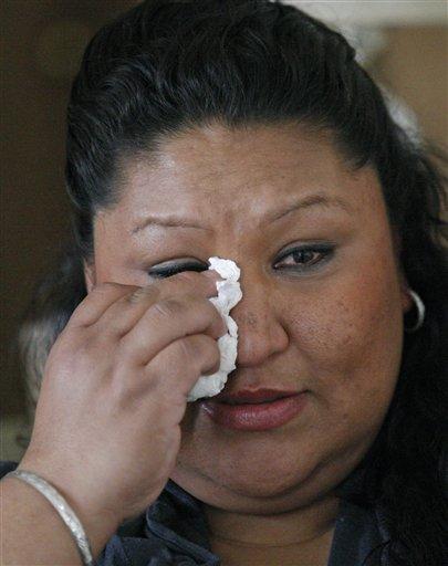 In this Feb. 28, 2012 photo, Madeline Hutchinson wipes a tear during an interview at her home in Salem, Ore. Pregnant with her seventh child and desperate to kick a methamphetamine habit, Hutchinson turned to a program from the local Medicaid provider that connected her with a mentor and other support that helped her stay off drugs and give birth to a healthy boy.  Emmanuel, now 2, was born drug-free and is the only one of her children still in her custody. But Hutchinson’s health provider can’t get reimbursed for much of the treatment she credits with saving her life, keeping her healthy and protecting the health of her child. (AP Photo / Rick Bowmer)