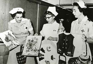 Nurses display handicrafts created by patients at the Columbia Park Hospital and Training Center in a 1968 biennial report. (Board of Control Records, Photographs, box 4, separated from State Institution Research Reports, box 76, folder 23)